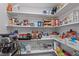 Organized pantry with white shelves, featuring a variety of food items and storage containers at 193 Jenny Ln, Timberlake, NC 27583