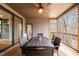 Relaxing screened porch with wood flooring, ceiling fan, and a dining table set for outdoor meals at 193 Jenny Ln, Timberlake, NC 27583