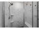 Contemporary shower with marble-patterned tiles, rainfall showerhead, and built-in seating at 193 Jenny Ln, Timberlake, NC 27583