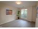 Bedroom featuring a light wood floor, a large window, and neutral-colored walls, creating a bright and inviting atmosphere at 2520 Friedland # 202, Raleigh, NC 27617
