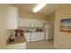 Well-lit kitchen featuring white cabinets, granite countertops, and modern appliances at 2520 Friedland # 202, Raleigh, NC 27617