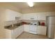 Kitchen with white cabinets and appliances with granite countertops and a tiled floor at 2520 Friedland # 202, Raleigh, NC 27617