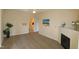 Light-filled living room with fireplace, adjacent half-bathroom, and light wood-look flooring at 2520 Friedland # 202, Raleigh, NC 27617