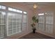 Sunroom with a ceiling fan, large windows and wood-look floors at 2520 Friedland # 202, Raleigh, NC 27617