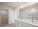 Spacious bathroom with double sink vanity and a large mirror, alongside a glass-enclosed shower at 2562 Summersby Dr, Mebane, NC 27302