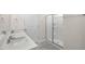 A well-lit bathroom with a double sink vanity and a glass-enclosed shower at 2562 Summersby Dr, Mebane, NC 27302