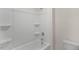 Clean bathroom featuring a tub and shower combination with built-in shelving and a bright white color scheme at 2562 Summersby Dr, Mebane, NC 27302