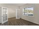 Bedroom or office with french doors, hardwood flooring, and an oversized window at 2562 Summersby Dr, Mebane, NC 27302