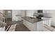 Modern kitchen with stainless appliances, granite counters, an island, and ample cabinet space at 2562 Summersby Dr, Mebane, NC 27302
