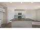 Well-lit kitchen with granite countertops, a center island, and stainless steel microwave at 2562 Summersby Dr, Mebane, NC 27302