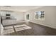 Open-concept living room with hardwood floors, a sliding glass door, and plenty of natural light at 2562 Summersby Dr, Mebane, NC 27302