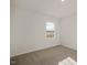 Bedroom featuring neutral carpet, freshly painted walls, and a large window providing natural light at 2573 Summersby Dr, Mebane, NC 27302