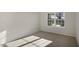 Bright bedroom with plush carpeting and a large window, offering ample natural light at 2573 Summersby Dr, Mebane, NC 27302