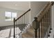 Beautiful staircase with hardwood floors, carpeted steps, and black wrought iron spindles at 2573 Summersby Dr, Mebane, NC 27302