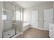 Bright bathroom with glass enclosed shower, soaking tub, and neutral tile at 27 Meath Ct # 215, Clayton, NC 27520