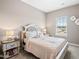 Comfortable bedroom featuring soft colors, bedside table with lamps, and natural light at 27 Meath Ct # 215, Clayton, NC 27520