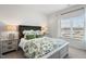 Cozy bedroom with neutral walls, bedside lamps, and a window at 27 Meath Ct # 215, Clayton, NC 27520