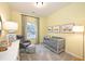 Bright bedroom featuring light yellow walls, a crib, a window, and decorative prints at 27 Meath Ct # 215, Clayton, NC 27520
