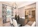 Elegant dining room with modern chandelier, stylish curtains, and a dark wood table at 27 Meath Ct # 215, Clayton, NC 27520