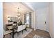 Bright dining room featuring a modern chandelier and seating for six at 27 Meath Ct # 215, Clayton, NC 27520