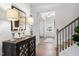 Inviting foyer with hardwood floors, decorative console table and staircase at 27 Meath Ct # 215, Clayton, NC 27520