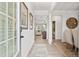 Bright foyer with light wood flooring, decorative wall art, and views into the dining and living areas at 27 Meath Ct # 215, Clayton, NC 27520