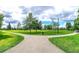 Well-manicured community green space featuring winding walking paths, trees, and grass at 27 Meath Ct # 215, Clayton, NC 27520
