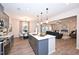 Open kitchen with an island, pendant lights, stainless appliances, flowing into the dining and living area at 27 Meath Ct # 215, Clayton, NC 27520
