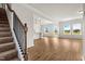 Open-concept home showcasing a staircase, wood flooring, natural light, and an eat-in kitchen at 27 Meath Ct # 215, Clayton, NC 27520