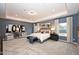 Spacious main bedroom with tray ceiling, recessed lights and a seating area by the windows at 27 Meath Ct # 215, Clayton, NC 27520