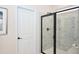 Modern shower with black hardware and marble tile surround at 27 Meath Ct # 215, Clayton, NC 27520