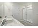 Bathroom featuring double sinks with quartz countertops and a frameless glass shower at 2735 Luxborough Ln, Mebane, NC 27302