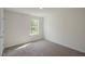 A cozy carpeted bedroom with a window offering natural light at 2735 Luxborough Ln, Mebane, NC 27302