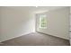 A bright bedroom features neutral carpet, paint, and a double-hung window at 2735 Luxborough Ln, Mebane, NC 27302