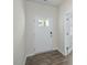 Home entryway with white walls, hardwood floors, and a glass front door at 2735 Luxborough Ln, Mebane, NC 27302