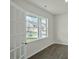 Flex room with hardwood floors, white walls, and a large window with neighborhood views at 2735 Luxborough Ln, Mebane, NC 27302