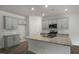 Stylish kitchen with gray cabinets, stainless steel appliances, granite countertops, and an island with a sink at 2735 Luxborough Ln, Mebane, NC 27302