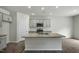 Bright kitchen with gray cabinetry, stainless steel appliances, granite countertops, and a large center island at 2735 Luxborough Ln, Mebane, NC 27302