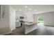 Modern kitchen featuring gray cabinets, stainless steel appliances, a large center island, and sliding glass door to the yard at 2735 Luxborough Ln, Mebane, NC 27302