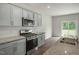 Kitchen with granite countertops, stainless steel appliances, and gray cabinets at 2735 Luxborough Ln, Mebane, NC 27302