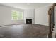 Inviting living room featuring hardwood floors, a cozy fireplace, and large window allowing abundant natural light at 2735 Luxborough Ln, Mebane, NC 27302