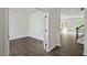 Bright living room featuring hardwood floors, white walls, and French doors at 2735 Luxborough Ln, Mebane, NC 27302