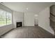 Bright living room featuring a fireplace, hardwood floors, and natural light streaming through a large window at 2735 Luxborough Ln, Mebane, NC 27302