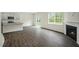 Open concept living area featuring hardwood floors, and a modern fireplace at 2735 Luxborough Ln, Mebane, NC 27302