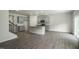 Open concept living space featuring gray cabinets, hardwood floors, and stainless appliances at 2735 Luxborough Ln, Mebane, NC 27302
