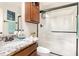 Cozy bathroom with a tile backsplash, granite counters, wood cabinets, and glass shower at 32 Colson Dr, Garner, NC 27529