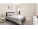 Neutral guest bedroom features a queen bed, carpeted floors, and a large window at 32 Colson Dr, Garner, NC 27529