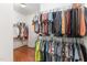 Walk-in closet with hardwood floors and ample storage capacity with dual hanging racks at 32 Colson Dr, Garner, NC 27529