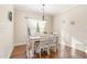 Cozy dining room with hardwood floors, pendant lighting, and a large window with sheer curtains at 32 Colson Dr, Garner, NC 27529