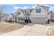Inviting home with beige siding, green shutters, and a spacious driveway leading to a two-car garage at 32 Colson Dr, Garner, NC 27529